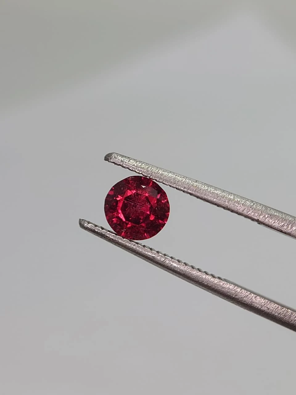 0.6ct Natural Round Faceted Malaya Garnet from Tanzania — view 3